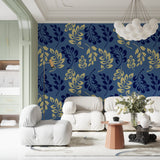 Blue and gold leaf pattern wallpaper in modern living room with gray sofa and natural light