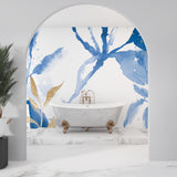Blue and gold watercolor floral wallpaper in modern living room creates serene atmosphere