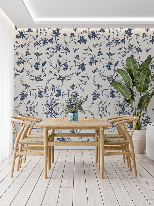 Blue bird floral wallpaper in bright modern living room showing pattern depth and scale