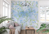 Blue Liberty floral wallpaper in bright modern living room creating fresh garden atmosphere