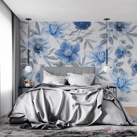 Blue watercolor floral wallpaper in a bright modern bedroom, creating a peaceful atmosphere