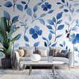 Blue floral wallpaper mural creating a serene atmosphere in a modern bedroom with natural light and minimal furniture
