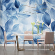 Blue watercolor leaf wallpaper creating a serene atmosphere in a modern living room with natural light