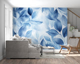 Watercolor blue leaf mural in a peaceful bedroom setting with minimal furniture