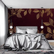 Burgundy and gold leaf wallpaper in an elegant dining room with crystal chandelier