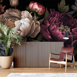 Dark burgundy peony wallpaper in modern living room with gray sofa and golden accents