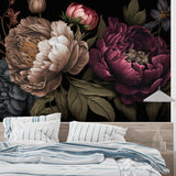 Dark floral wallpaper in home office with brass desk lamp
