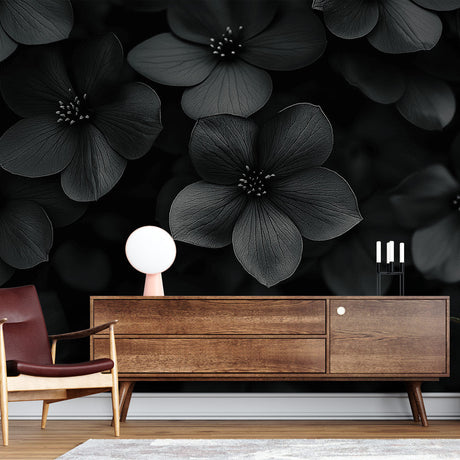 Black floral wallpaper creating dramatic impact in a modern living room with minimalist furniture and natural lighting