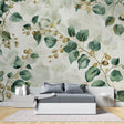 Botanical wallpaper with green leaves and gold berries in a bright modern living room