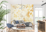 Golden leaf wallpaper mural in bright modern living room showing natural light interaction