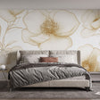 Golden floral line art wallpaper creating an elegant atmosphere in a bright modern living room with minimalist furniture