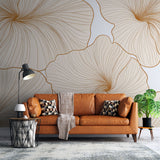 Gold floral line art wallpaper creating an elegant backdrop in a bright modern living room with minimal furniture