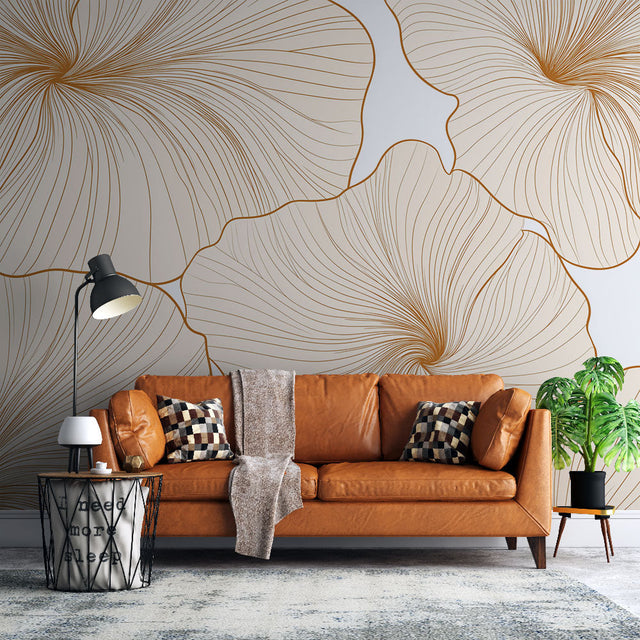Gold floral line art wallpaper creating an elegant backdrop in a bright modern living room with minimal furniture