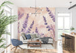 Lavender floral wallpaper mural in modern living room with gray sofa and natural light
