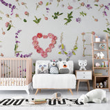 Pink roses Love Letters floral wallpaper in a bright nursery with white furniture