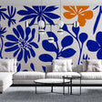Modern floral wallpaper with blue and orange blooms creating a stunning accent wall in a bright living room