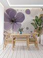 Modern purple and gold floral wallpaper in a bright living room setting with minimal furniture