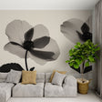 Black and white floral wallpaper creating dramatic impact in a modern living room with minimal furniture