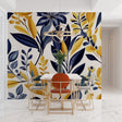 Navy blue and gold leaf wallpaper mural in modern living room setting with grey sofa and natural light