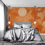 Orange floral wallpaper with moon motif styled in bohemian reading nook