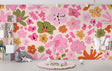 Pink and orange floral wallpaper mural in a bright modern living room, creating a cheerful accent wall