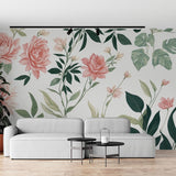 Pink rose and monstera wallpaper creating a fresh garden feel in a bright living room with modern furniture