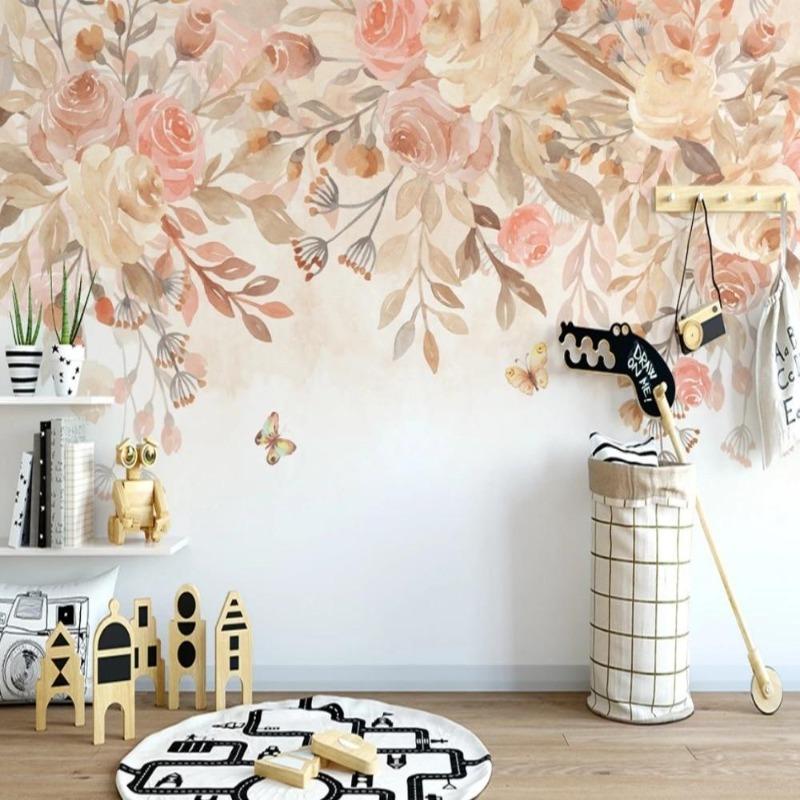 Floral wall mural with soft pink roses and butterflies adding charm to a nursery space