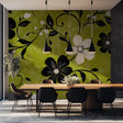 Green floral wallpaper with black and white blooms styled in modern dining room with natural light