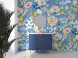 Floral wall mural with watercolor blue and peach blooms in a bright living room setting