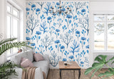 Watercolor botanical wallpaper brightening a cozy bedroom with white furniture