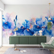 Blue iris watercolor wallpaper in a bright modern living room, showing how floral murals create a fresh, artistic atmosphere