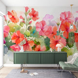 Watercolor Floral Mural displayed in bright living room, showing geranium garden pattern with soft pink and coral blooms