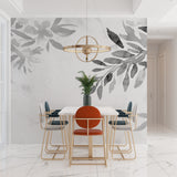 Botanical wallpaper featuring grey leaves in a bright home office space