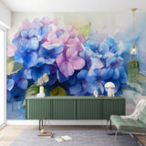 Hydrangea floral wallpaper in bright modern living room, showing blue and pink watercolor blooms creating a fresh garden feel