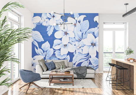 Large white floral wallpaper creating a stunning focal point in a modern living room with blue accents