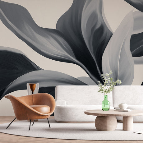 Modern black and grey leaf wallpaper in a minimalist living room creating a sophisticated accent wall