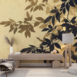 Black and gold botanical wallpaper creating drama in a modern living room with tall windows