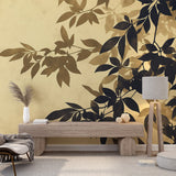 Black and gold botanical wallpaper creating drama in a modern living room with tall windows