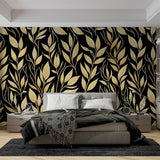 Black and gold leaf wallpaper creating dramatic impact in a modern dining room with ambient lighting