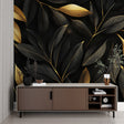 Black and gold leaf wallpaper creating drama in a modern dining room with crystal chandelier