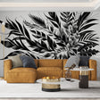 Black and white botanical wallpaper creating dramatic impact in a modern living room with minimalist furniture