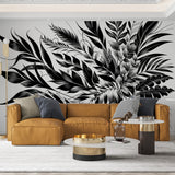 Black and white botanical wallpaper creating dramatic impact in a modern living room with minimalist furniture