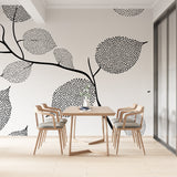 Black and white dotted leaf wallpaper in a bright modern home office, showing how the pattern creates depth and interest