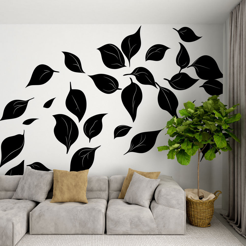 Black and white leaf mural wallpaper in a modern living room creating dramatic contrast against furniture