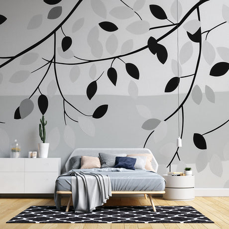 Black and white leaf pattern mural wallpaper in a modern living room, creating a clean and fresh atmosphere