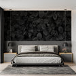 Black and white leaf wallpaper in modern living room creating dramatic focal point