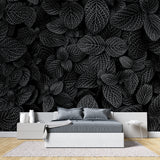 Home office featuring black and white leaf pattern wallpaper