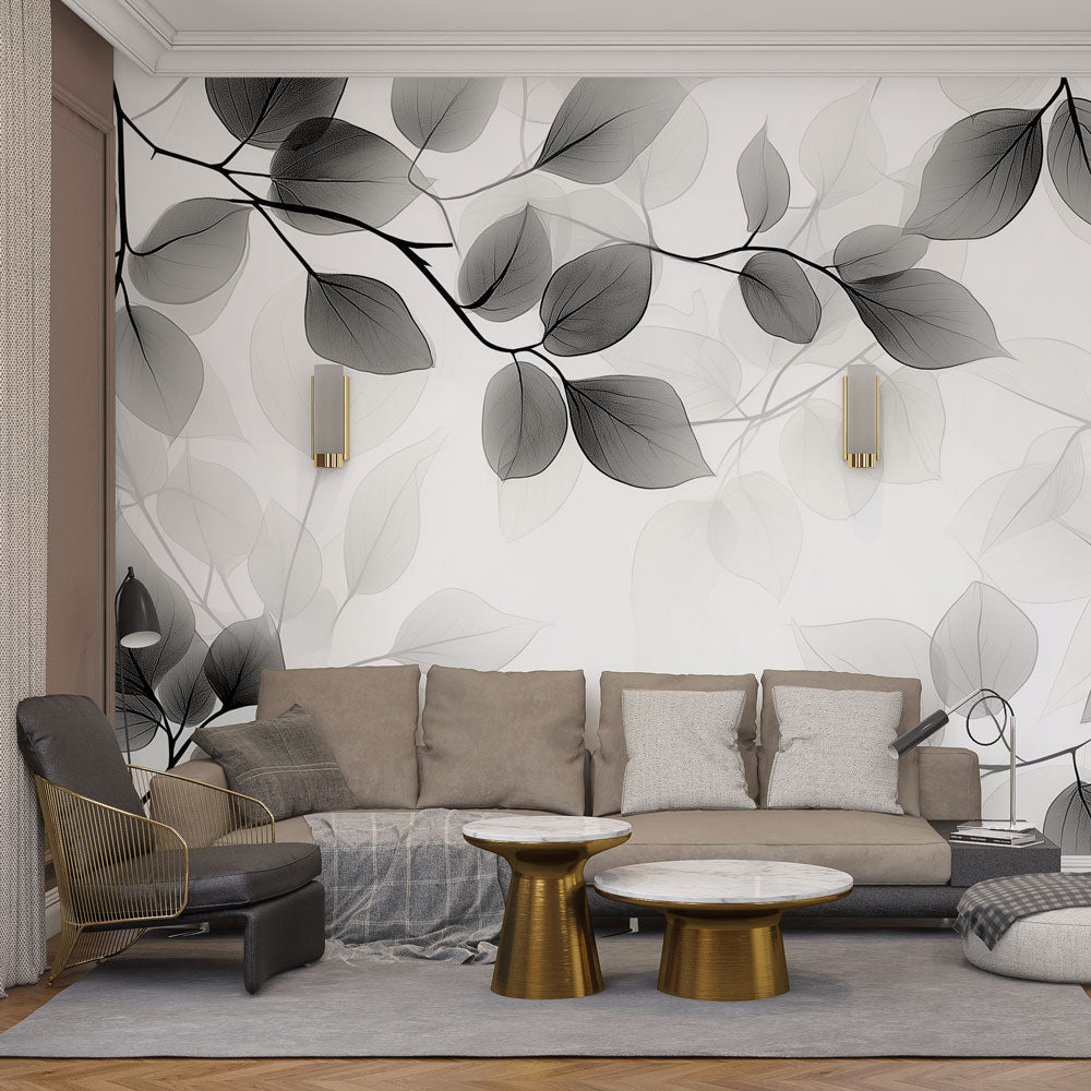 Black and white botanical wallpaper with translucent leaves creating a dramatic statement wall in a modern living room