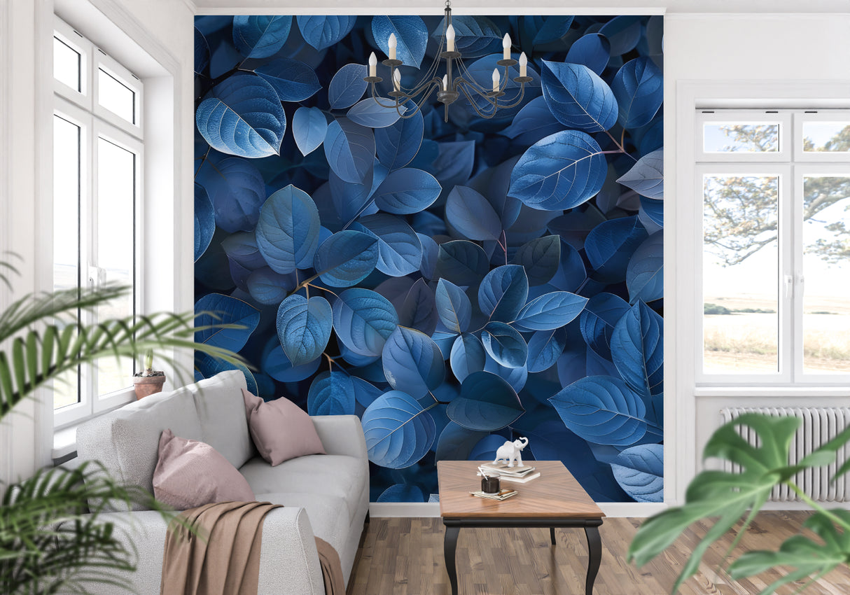 Blue leaf wallpaper mural creating depth in a modern living room with grey sofa and natural light