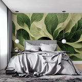 Green leaf mural wallpaper bringing nature into a cozy bedroom setting